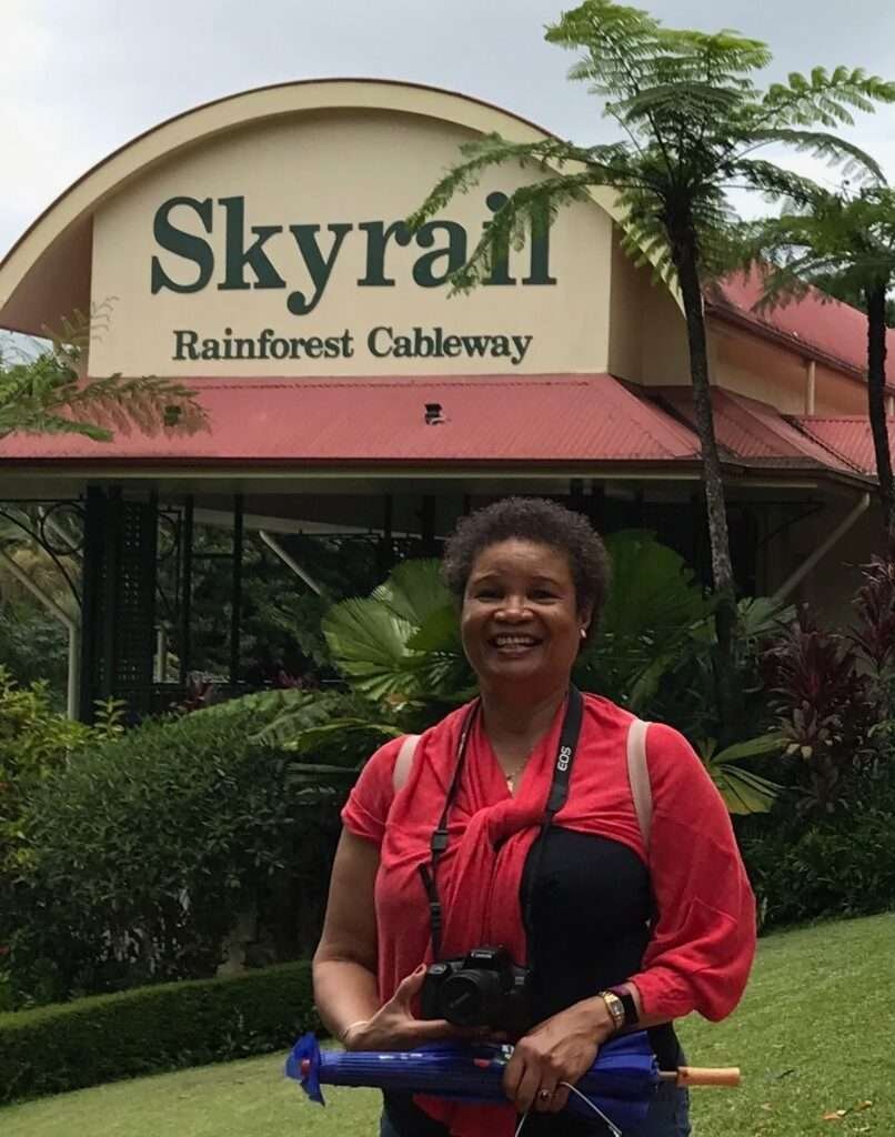 Molly from Mollywozhere travel blog standing in front of Skyrail Rainforest Cable car in Kuranda, Australia.