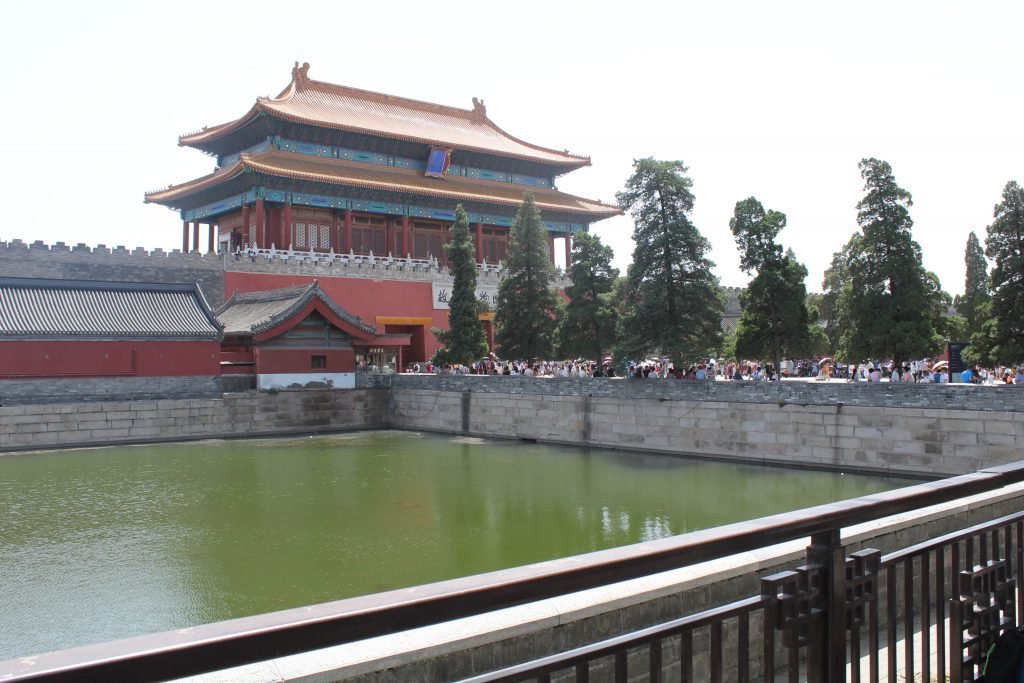 Molly from Mollywozhere travel blog at the entrance to the Forbidden City, surrounded by moat, Beijing.