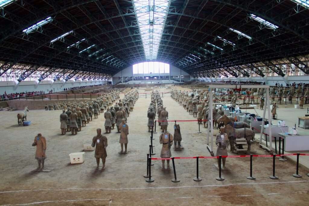 Molly from Mollywozhere showing close up view of warriors in the restoration and excavation area of Terracotta Army, Xi'an, China.