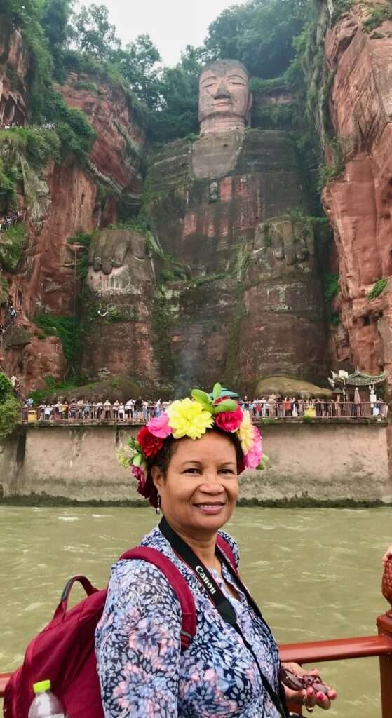 Molly from Mollywozhere travel blog on a boat looking at the Giant Buddha, Leshan, China.