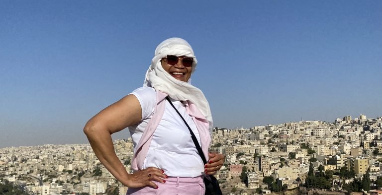 Molly from Mollywozhere standing in Amman Citadel, Jordan, looking across to Amman Citadel.