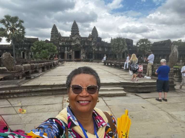 Molly from Mollywozhere travel blog standing in front of Angkor Wat, Cambodia.