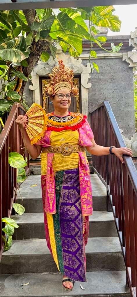 Molly of Mollywozhere wearing a colourful traditional Mesangih Balinese dress, Bali, Indonesia.
