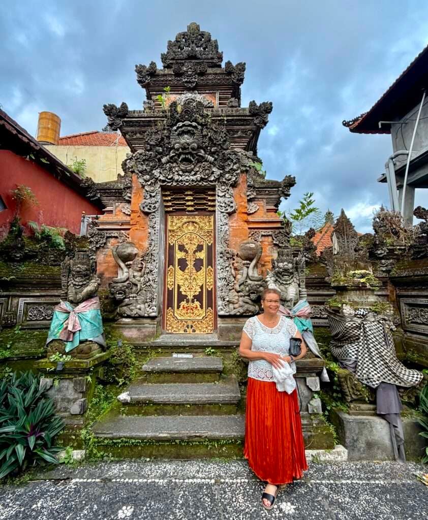 Molly from Mollywozhere travel blog standing in front of a temple in Ubud Palace, Bali.