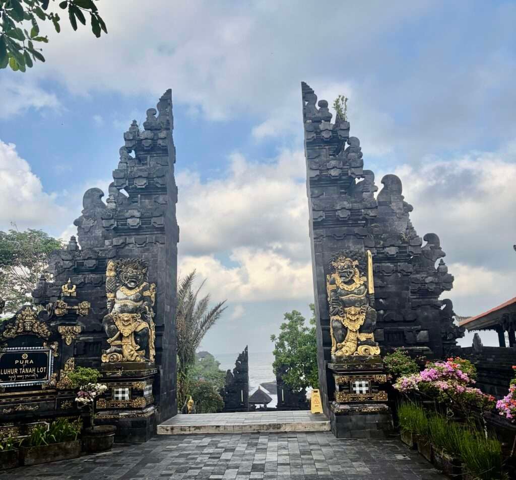 Molly from Mollywozhere travel blog at the entrance gate - Pura Luhur Tahah Lot Temple, Bali.