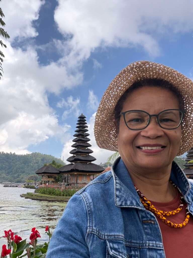 Molly from Mollywozhere standing in front of Ulun Danu Beratan Temple,Bali.