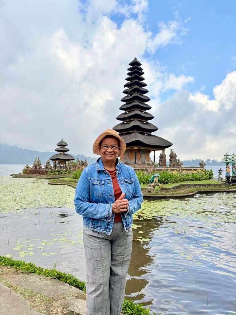 Molly from Mollywozhere standing in front of Ulun Danu Beratan Temple,Bali.