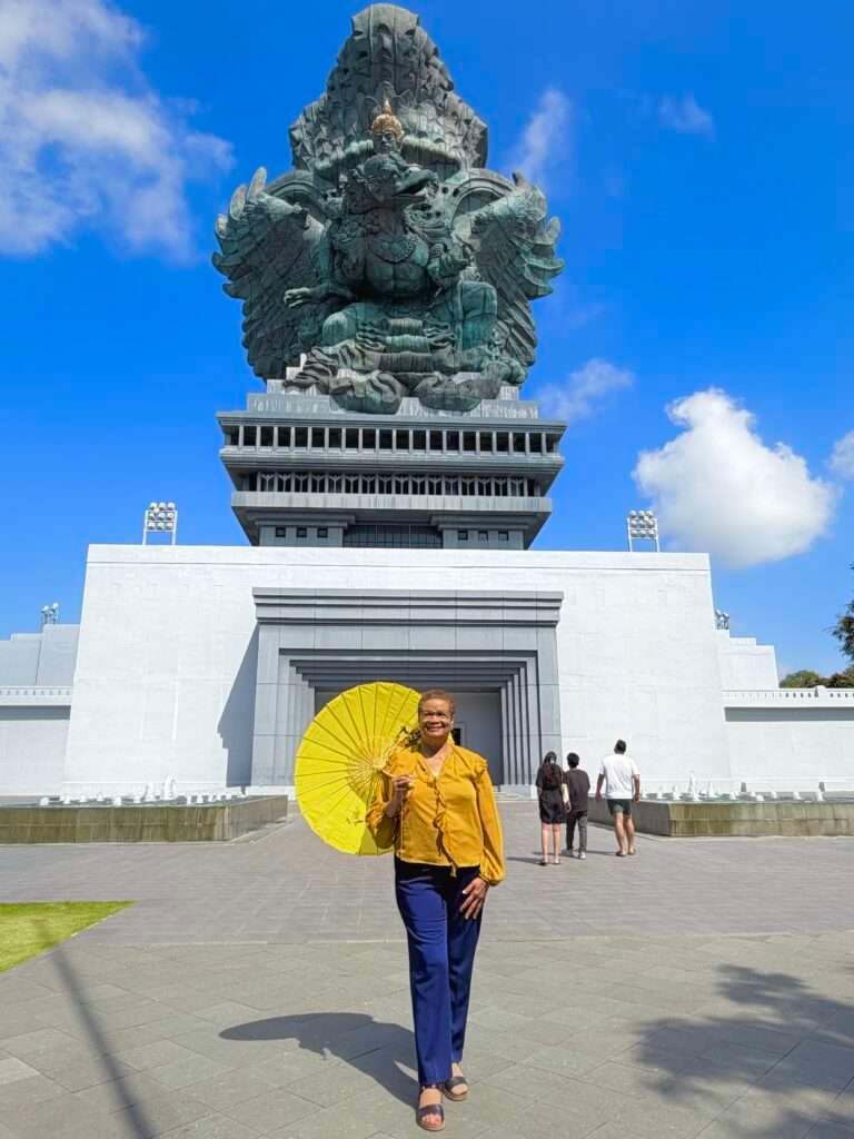 Molly from Mollywozhere travel blog standing in front of the colossus Garuda Wisnu Kencana (GWK), Bali.