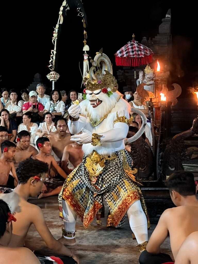 Molly from Mollywozhere travel blog watching the "white monkey" dance in the Kecat Dance & Fire Show in Uluwatu, Bali, Indonesia.