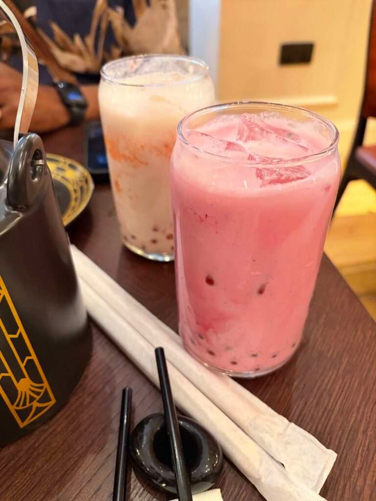 Molly from Mollywozhere travel blog showing dragon and vanilla bubble tea from her afternoon tea with a twist at the Dim Sum Library, London.