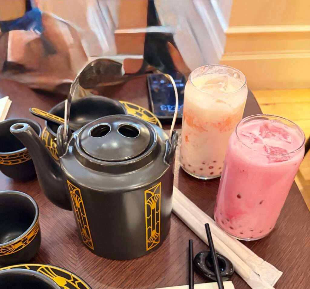 Molly from Mollywozhere travel blog showing dragon and vanilla bubble tea and Chinese tea from her afternoon tea with a twist at the Dim Sum Library, London.