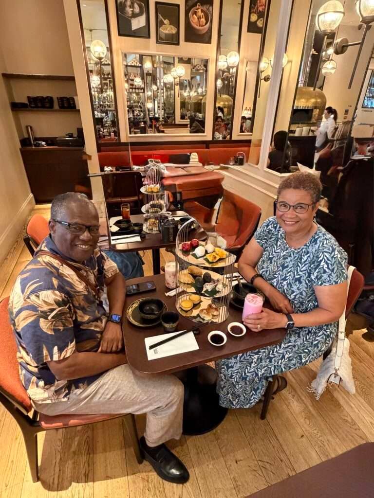Molly from Mollywozhere travel blog having afternoon tea with a twist with her partner at the Dim Sum Library, London.