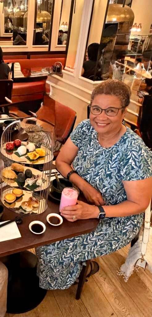 Molly from Mollywozhere travel blog enjoying an afternoon tea with a twist at the Dim Sum Library, London.