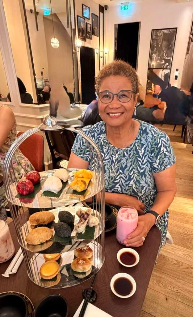 Molly from Mollywozhere travel blog having an afternoon tea with a twist with dragon and vanilla bubble tea and Chinese tea at the Dim Sum Library, London.