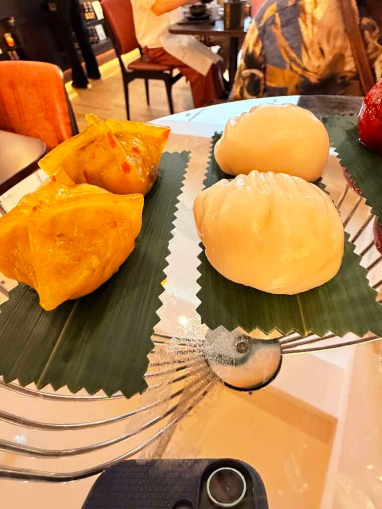 Molly from Mollywozhere travel blog showing a selection of dumplings of her afternoon tea with a twist at the Dim Sum Library, London.