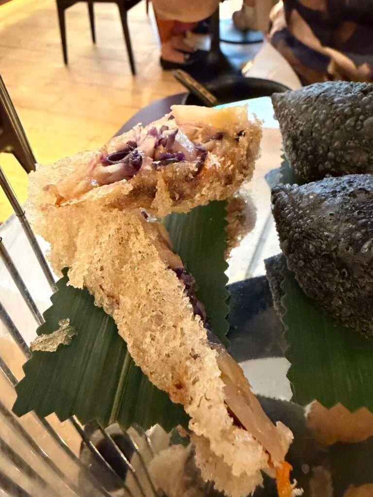 Molly from Mollywozhere travel blog showing a selection of crisp, flaky, crispy pastry of her afternoon tea with a twist at the Dim Sum Library, London.