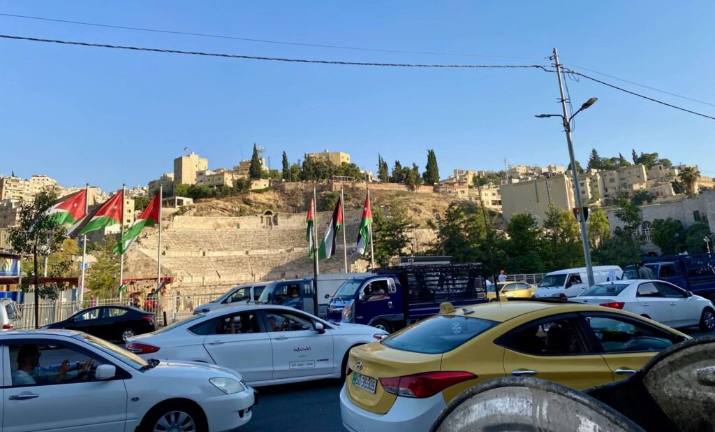 Molly from Mollywozhere travel blog crossing a busy road outside the Roman Theatre,Amman, Jordan.