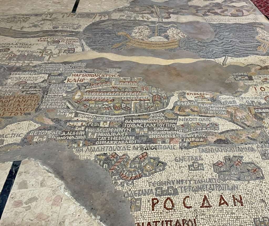 Molly from Mollywozhere travel blog showing a close up of the mosaic inside the Greek Orthodox Basilica of Saint George, Jordan.