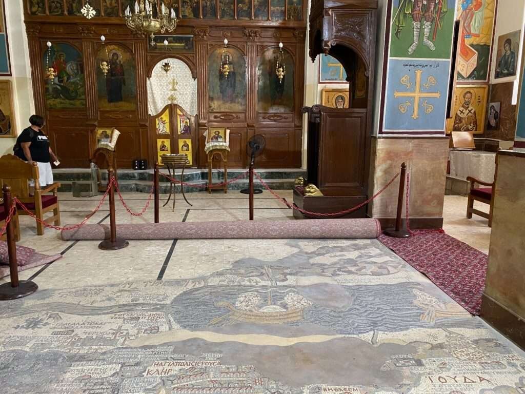 Molly from Mollywozhere standing inside the Basilica of Saint George, Madaba, Jordan.