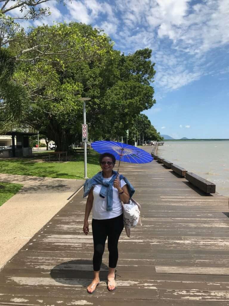 Molly from Mollywozhere travel blog walking along Cairns Esplanade, Australia.